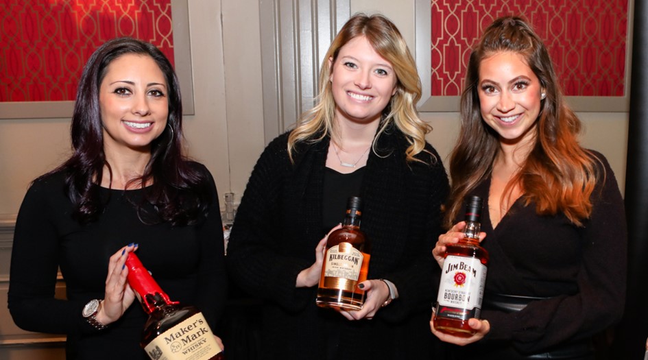 Girls with whiskey bottles at whiskey revival